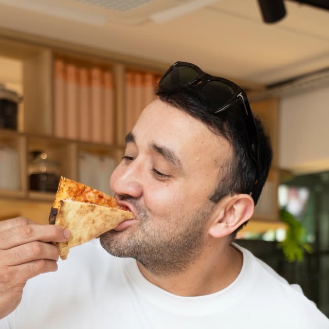 A slice of wood-fired sourdough pizza at Bobo & Wild