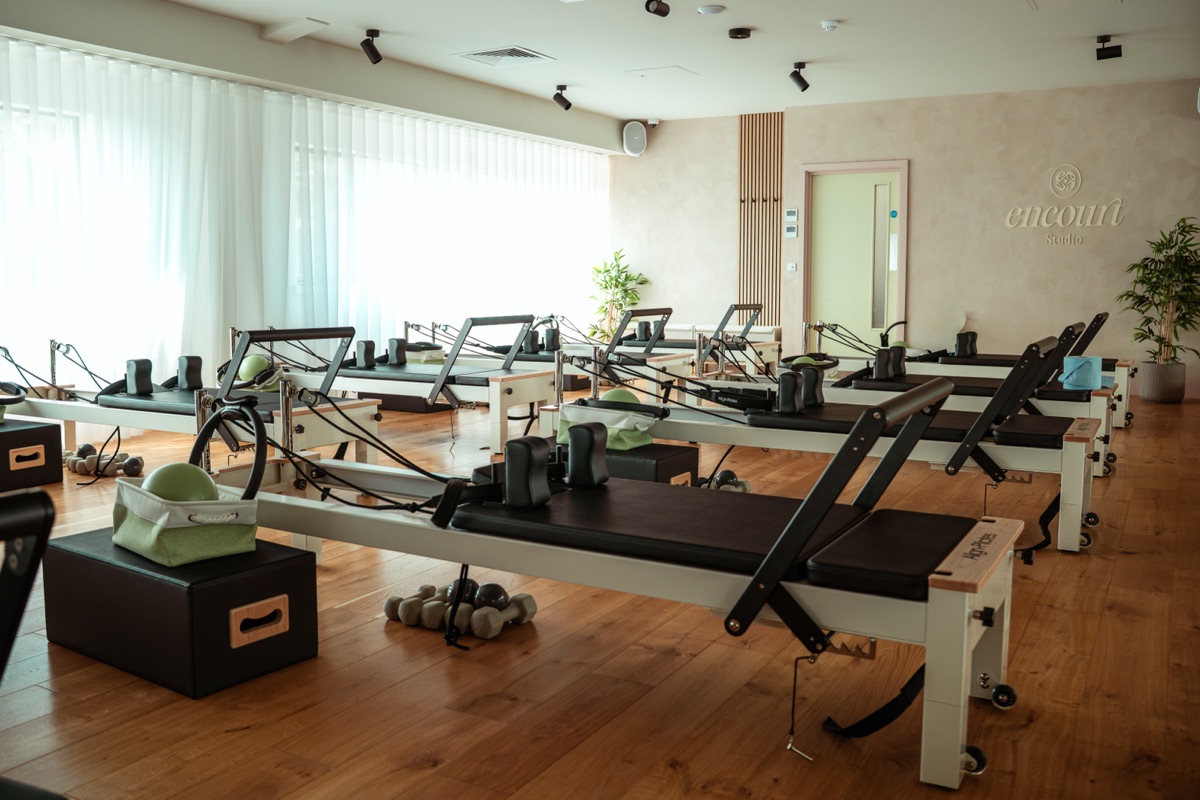 Row of Align-Pilates reformer machines in the Encourt Pilates studio